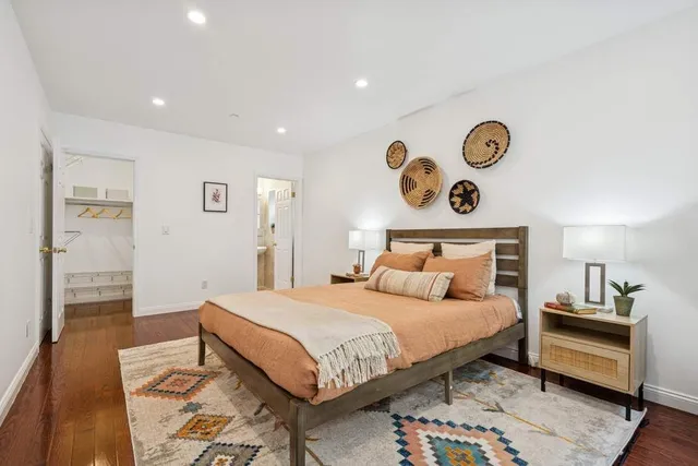 a living room with a bed furniture and a large window