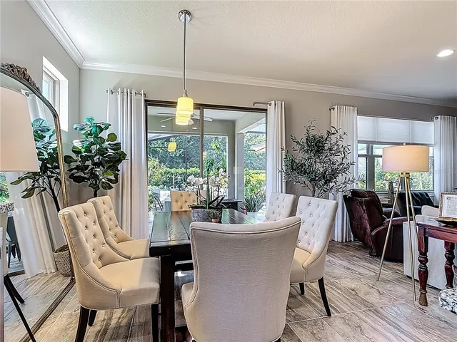 a bedroom with a bed a lamp on desk and chair