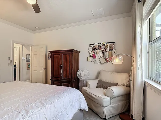 a living room with furniture a large window and a table