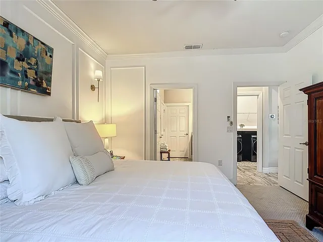 a living room with patio furniture and a potted plant