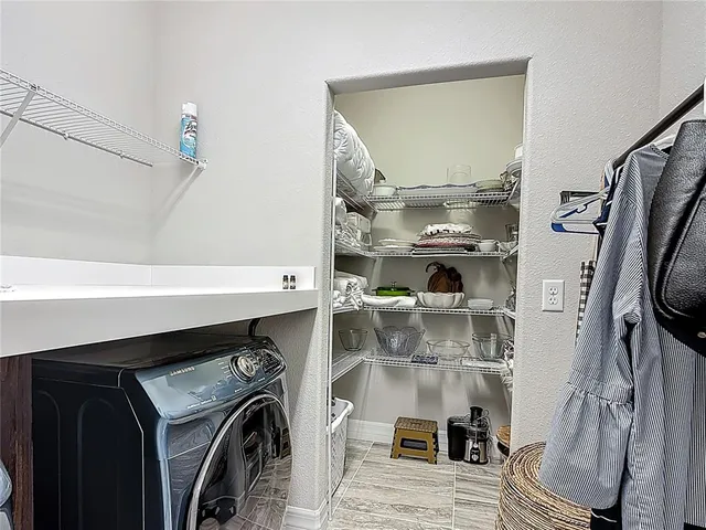 a view of a house with a yard and potted plants