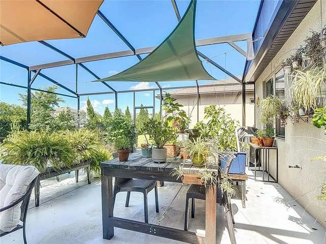an aerial view of a house with outdoor space and a swimming pool