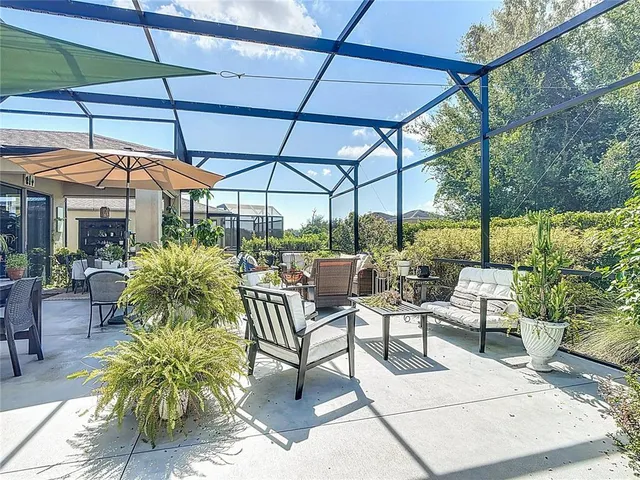 an aerial view of a house with swimming pool and outdoor seating