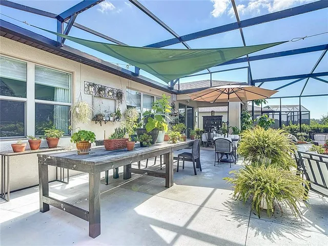 an aerial view of a house with garden space and outdoor seating