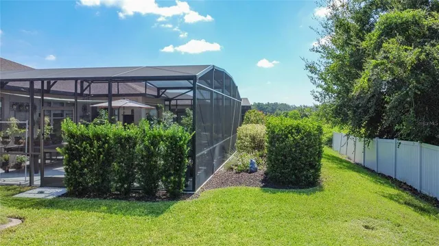 an aerial view of a house with yard swimming pool and outdoor seating