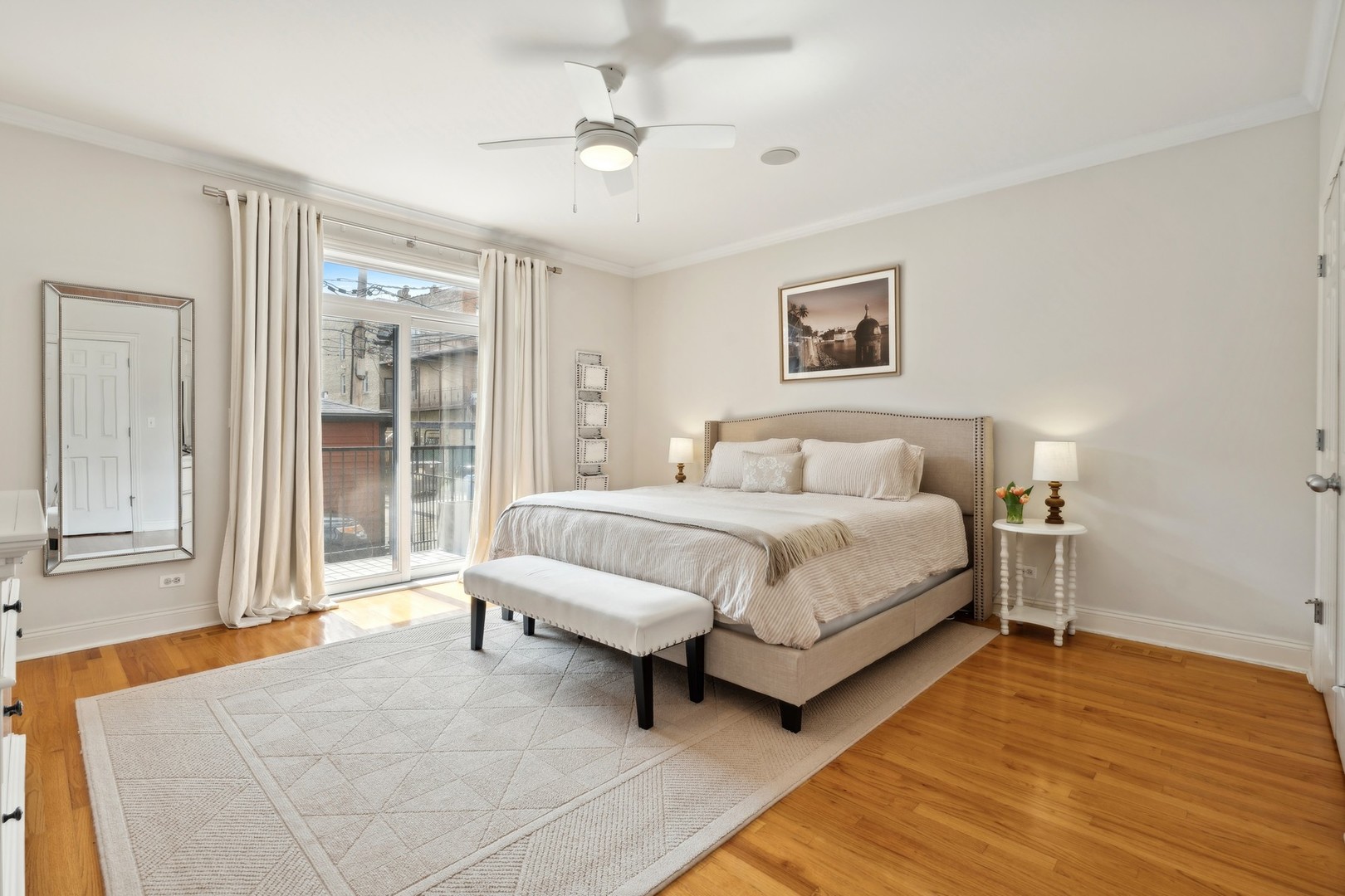 2147 West Rice Street, Unit 1W Chicago, IL 60622 - Photo 11 of 27 a spacious bedroom with a bed and a chandelier