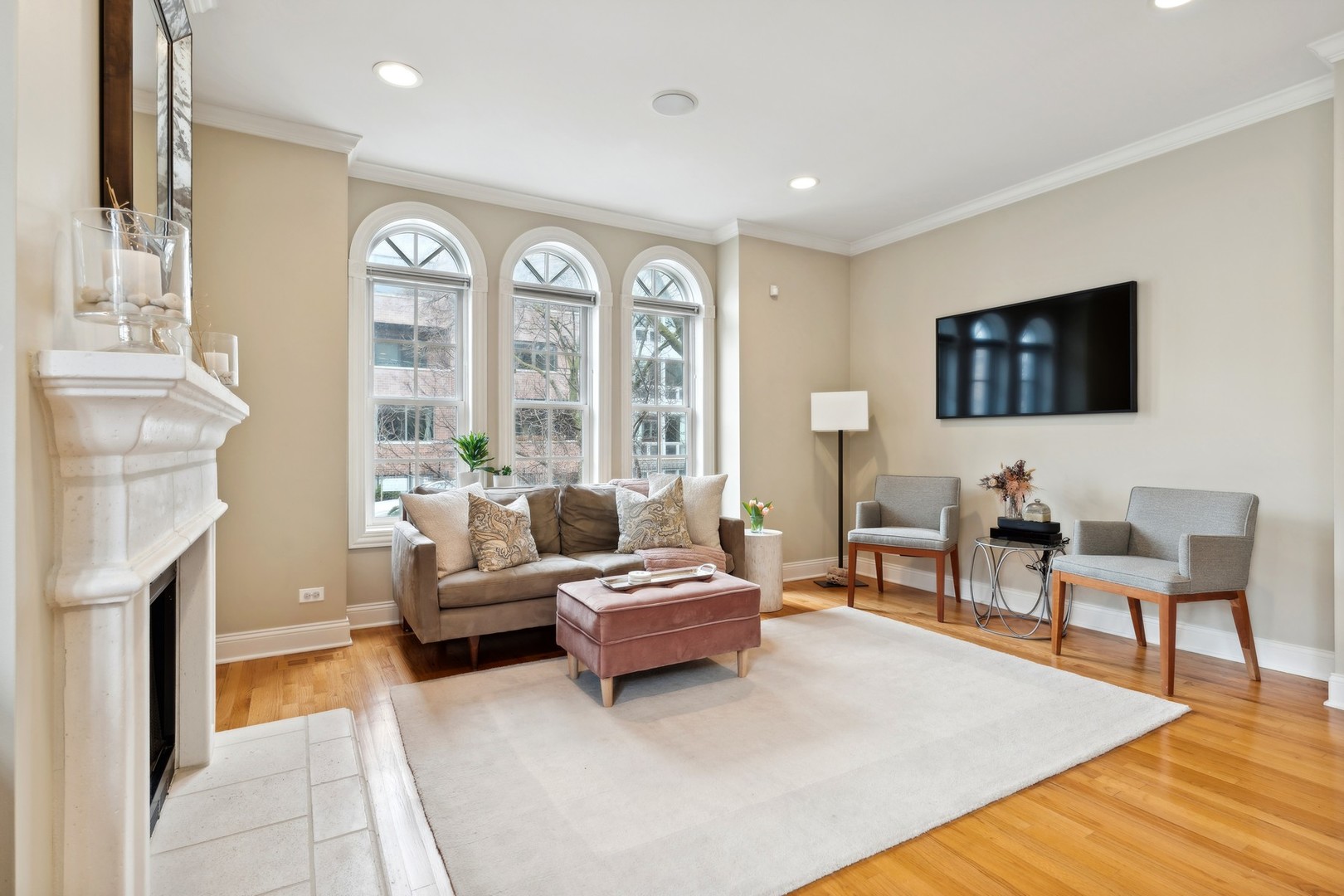 2147 West Rice Street, Unit 1W Chicago, IL 60622 - Photo 4 of 27 a living room with furniture a fireplace and a flat screen tv