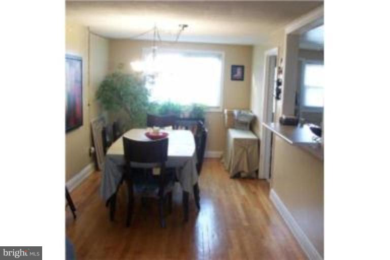 1363 Kenton Road Parkville, MD 21234 - Photo 3 of 9 a view of a dining room with furniture and wooden floor