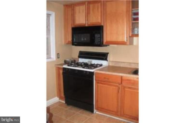 1363 Kenton Road Parkville, MD 21234 - Photo 5 of 9 a kitchen with a stove and a microwave