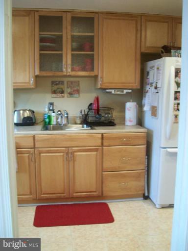 1363 Kenton Road Parkville, MD 21234 - Photo 6 of 9 a kitchen with stainless steel appliances white cabinets and a refrigerator