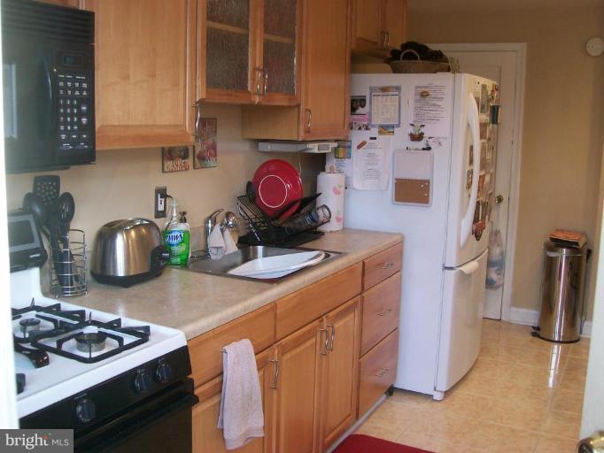 1363 Kenton Road Parkville, MD 21234 - Photo 7 of 9 a kitchen with a sink stove and refrigerator