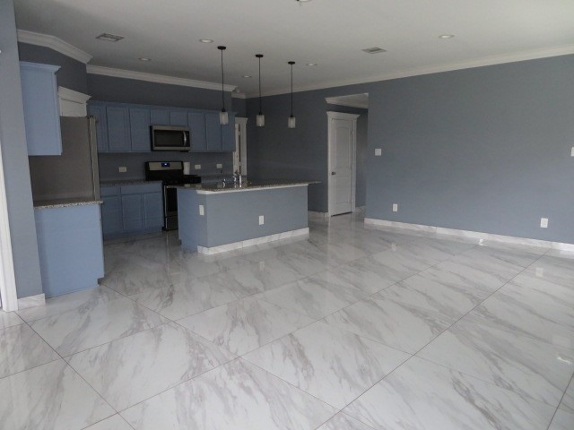 23210 Barberry Crk Trail Spring, TX 77373 - Photo 29 of 33 a large kitchen with cabinets and stainless steel appliances