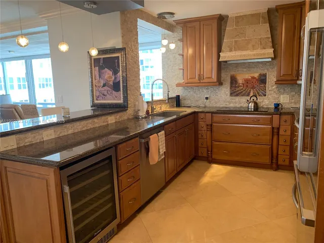 a kitchen with stainless steel appliances granite countertop a sink and cabinets
