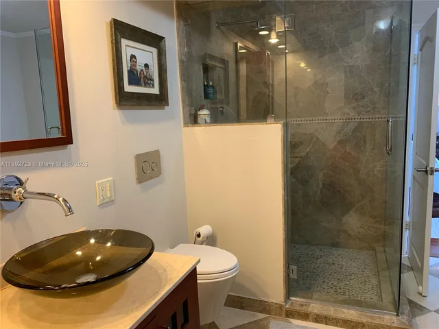 a bathroom with a sink toilet and shower