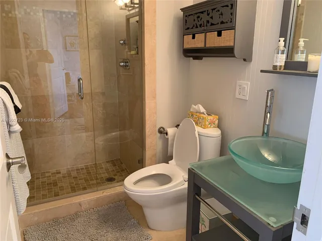 a bathroom with a sink toilet and shower