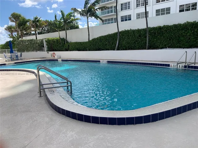 a view of a swimming pool with a yard