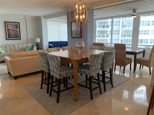 a view of a dining room with furniture and chandelier