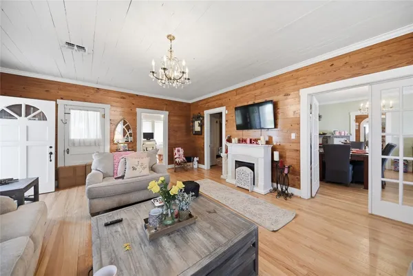 a living room with furniture a fireplace and a flat screen tv