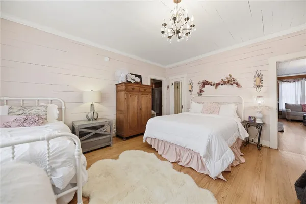 a bedroom with a bed and a chandelier