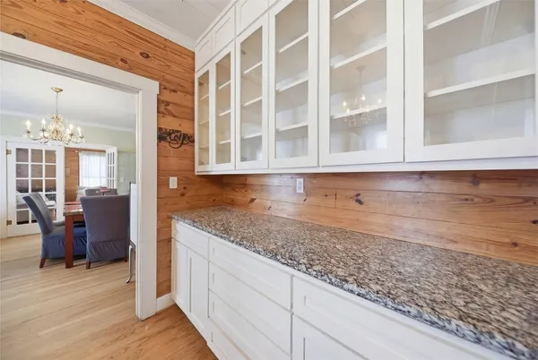 a view of a kitchen with granite countertop cabinets and wooden floor