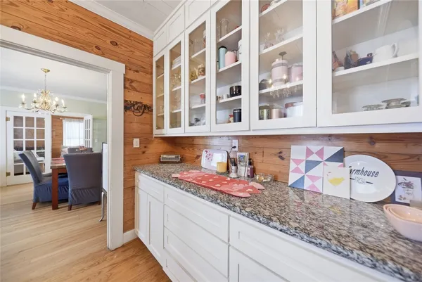 a kitchen with granite countertop lots of clutter and stainless steel appliances