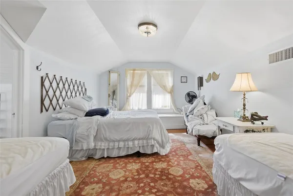 a bedroom with bed and a window