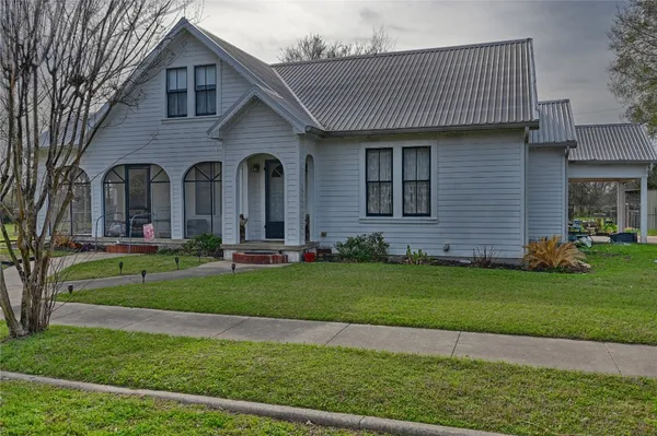 a front view of a house with a garden