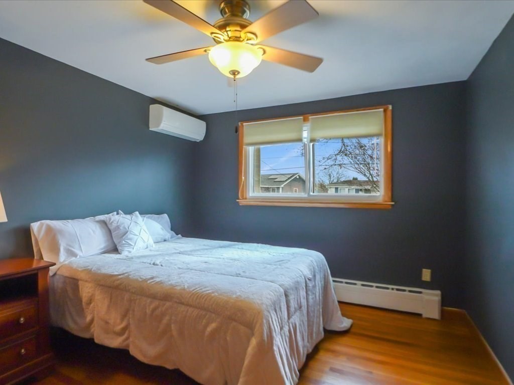 11 Benson Street Worcester, MA 01604 - Photo 19 of 40 a bedroom with a large bed and a chandelier