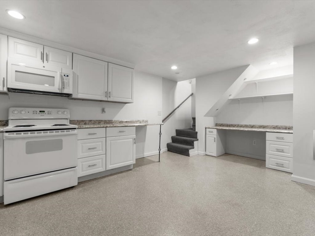 11 Benson Street Worcester, MA 01604 - Photo 26 of 40 a kitchen with white cabinets and white appliances