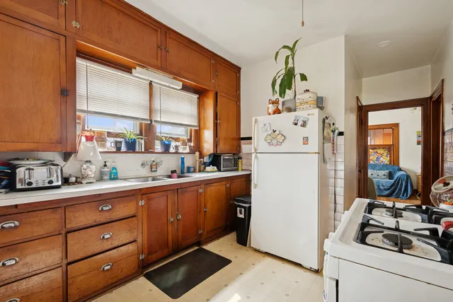 a white refrigerator freezer sitting inside of a kitchen