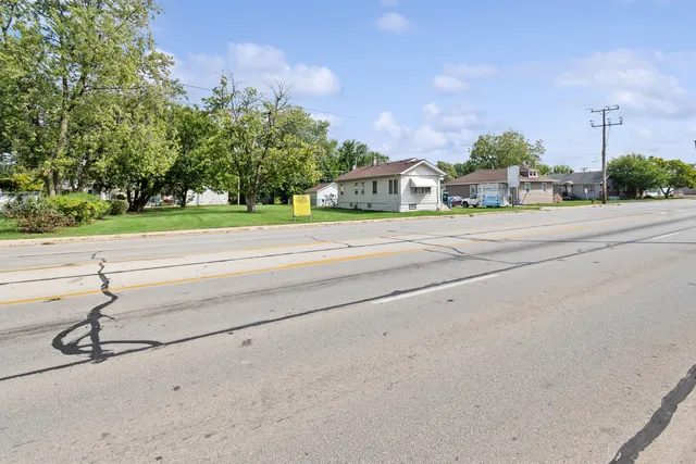 a front view of a house with a yard and trees