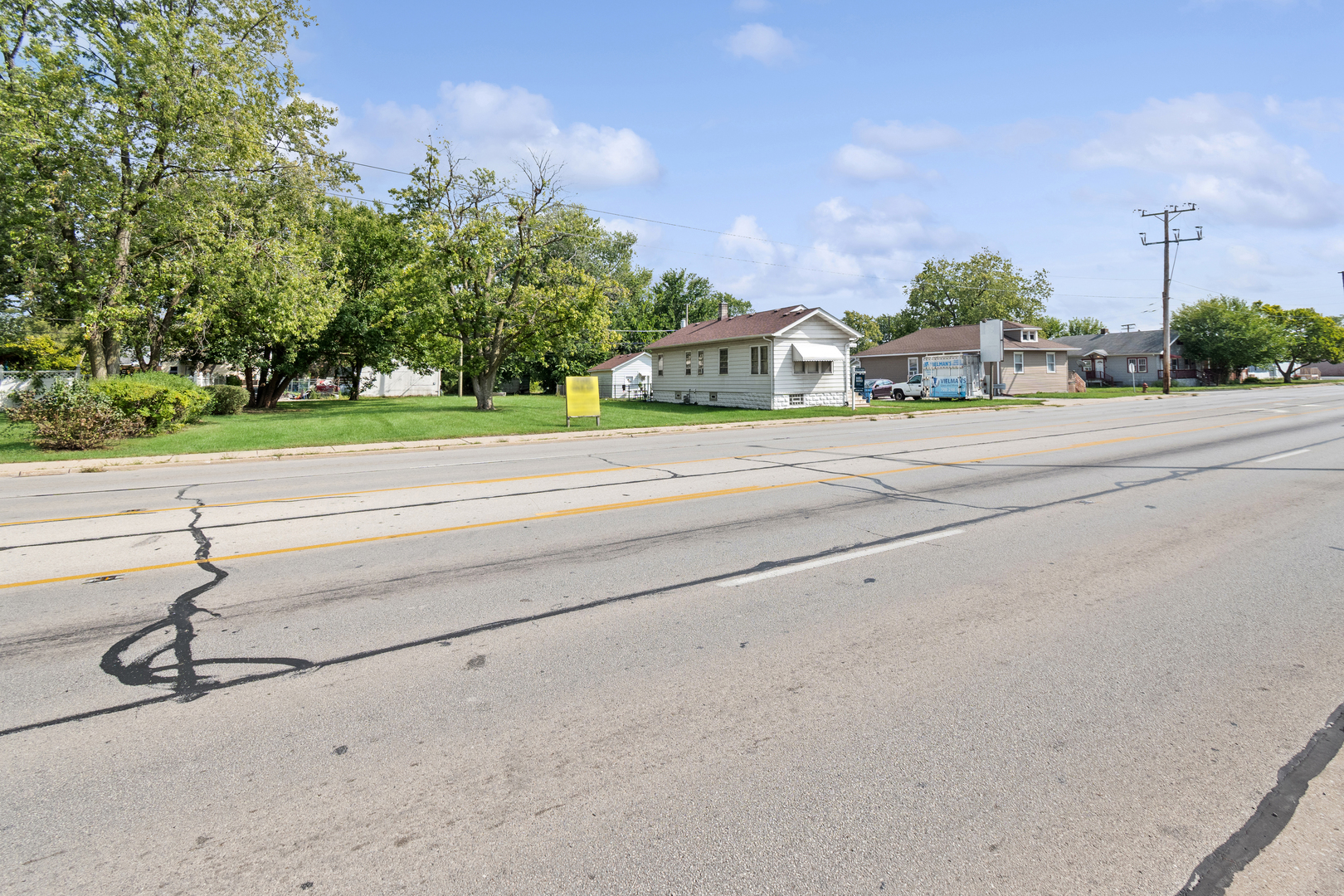 3117 Chicago Road Steger, IL 60475 - Photo 23 of 23 a front view of a house with a yard and trees