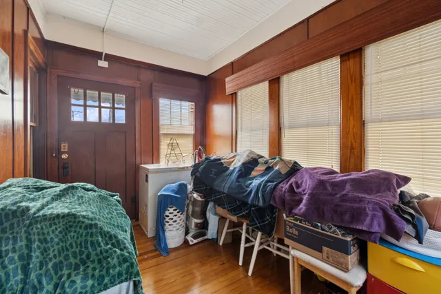 a bed room with a bed and a chair