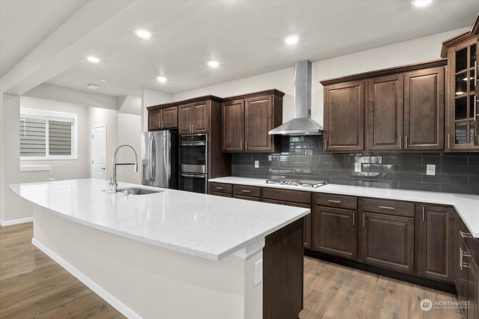 4308 233rd Place Southeast Bothell, WA 98021 - Photo 11 of 39 a large kitchen with stainless steel appliances a sink dishwasher a stove a refrigerator and a oven with wooden cabinets