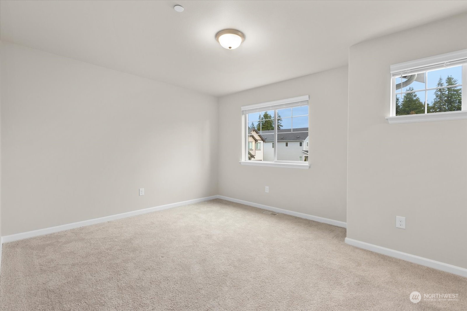 4308 233rd Place Southeast Bothell, WA 98021 - Photo 14 of 39 an empty room with windows and painting on the wall
