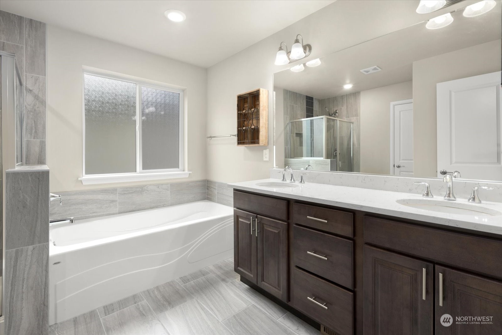 4308 233rd Place Southeast Bothell, WA 98021 - Photo 24 of 39 a bathroom with a tub a sink double vanity and a mirror