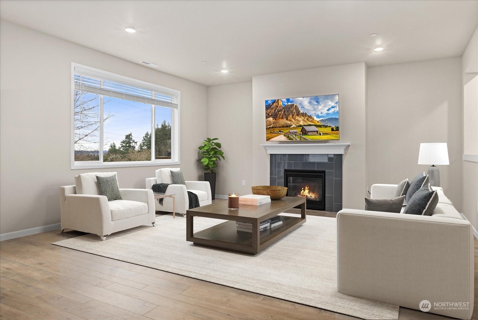 4308 233rd Place Southeast Bothell, WA 98021 - Photo 5 of 39 a living room with furniture a fireplace and a flat screen tv