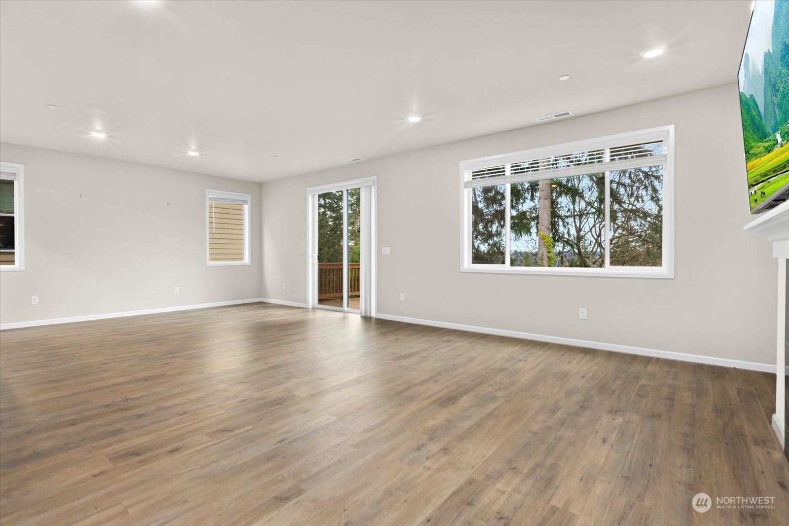 4308 233rd Place Southeast Bothell, WA 98021 - Photo 7 of 39 a view of an empty room with wooden floor and a window