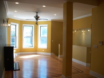 4852 South Prairie Avenue, Unit 1A Chicago, IL 60615 - Photo 3 of 15 a view of an empty room with wooden floor and a window