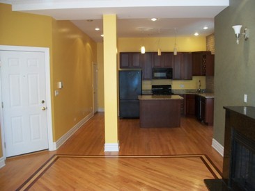 4852 South Prairie Avenue, Unit 1A Chicago, IL 60615 - Photo 4 of 15 a kitchen with stainless steel appliances granite countertop a refrigerator and a stove top oven