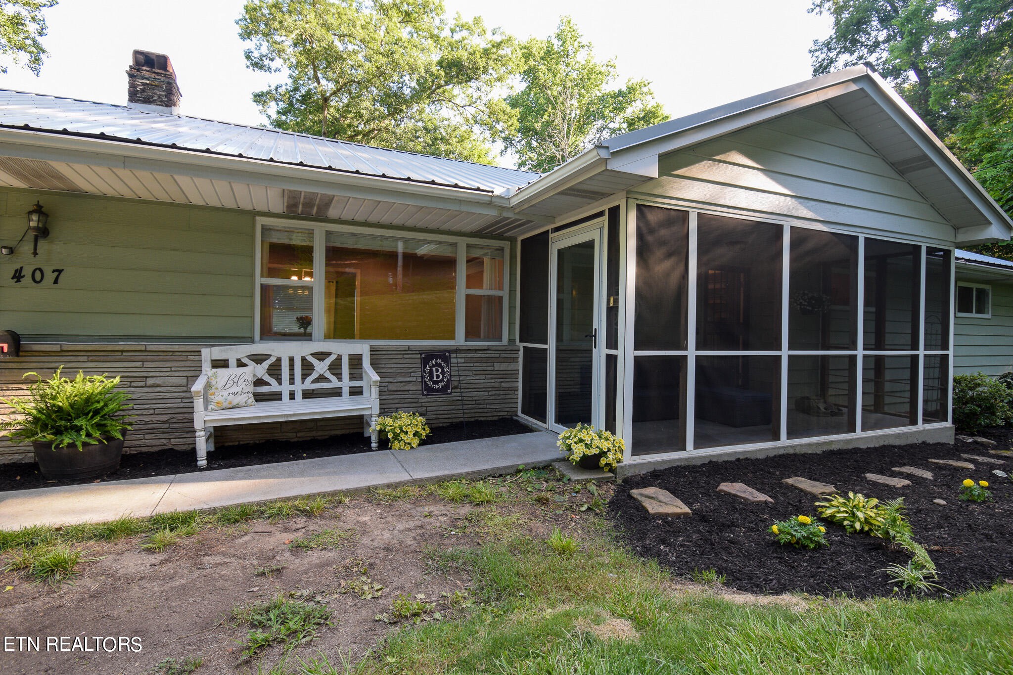 a front view of a house with a garden
