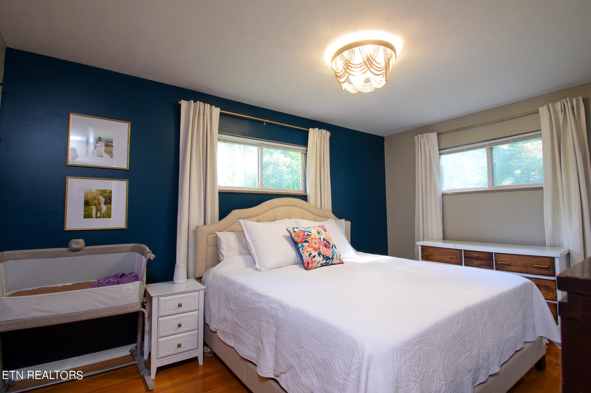 407 Delaware Avenue Oak Ridge, TN 37830 - Photo 14 of 40 a bedroom with a bed and a chandelier