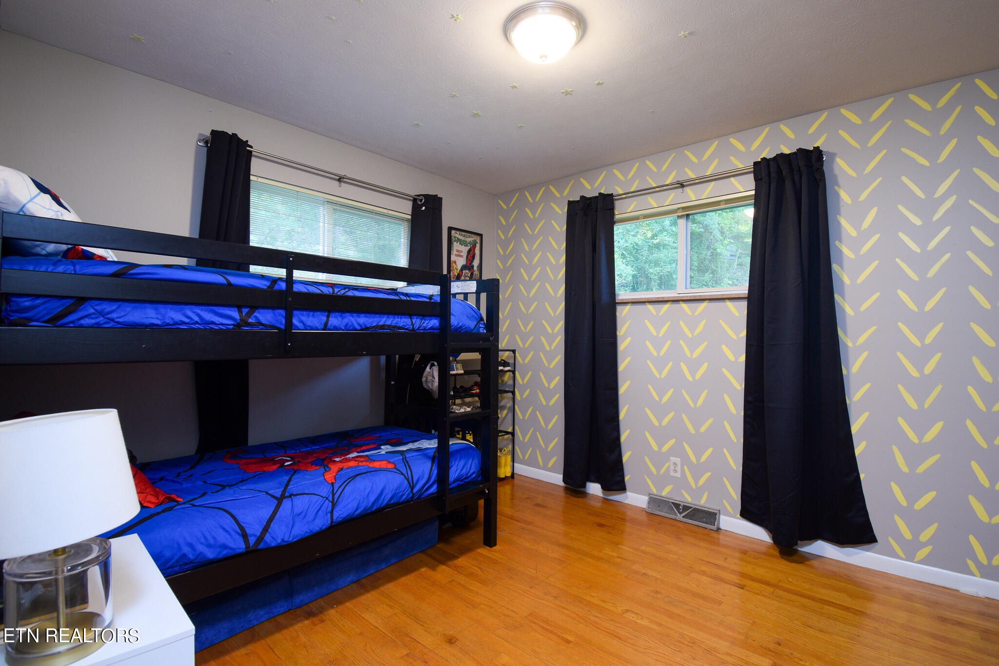 407 Delaware Avenue Oak Ridge, TN 37830 - Photo 21 of 40 a bedroom with a bed window and a flat screen tv