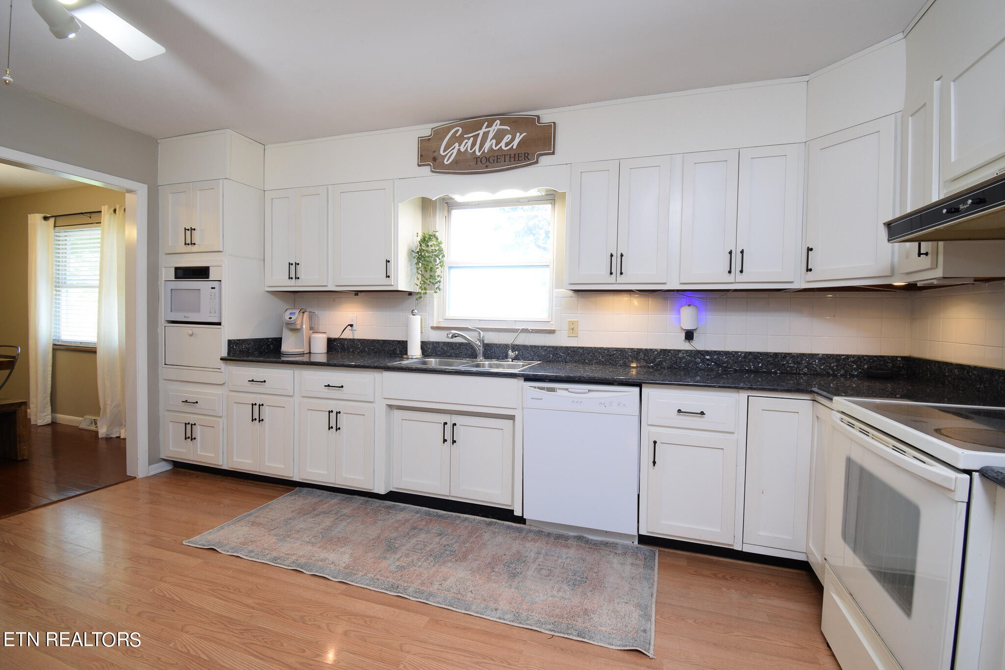 407 Delaware Avenue Oak Ridge, TN 37830 - Photo 3 of 40 a kitchen with granite countertop white cabinets and white appliances