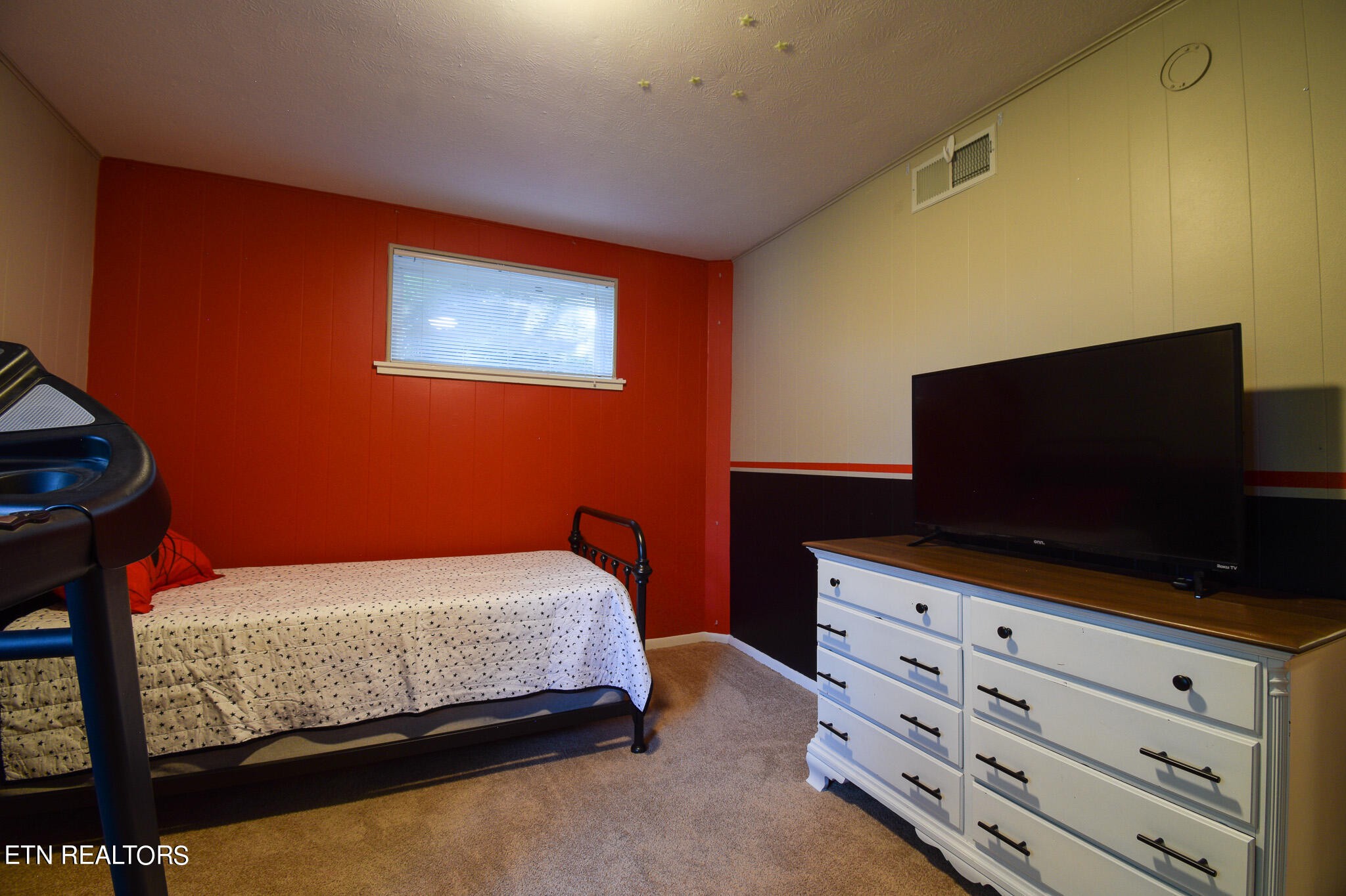 407 Delaware Avenue Oak Ridge, TN 37830 - Photo 31 of 40 a bedroom with a bed and a flat screen tv