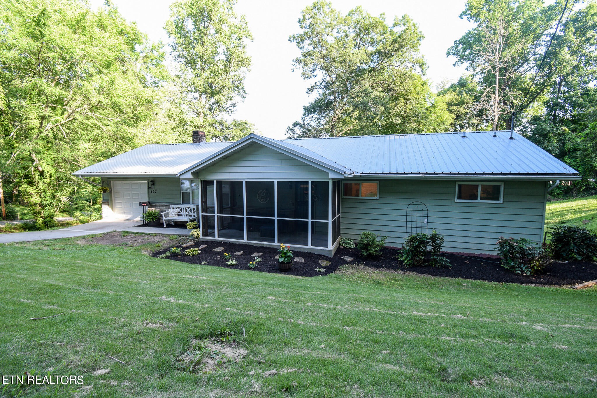 407 Delaware Avenue Oak Ridge, TN 37830 - Photo 37 of 40 a view of a house with a yard pathway and a large tree