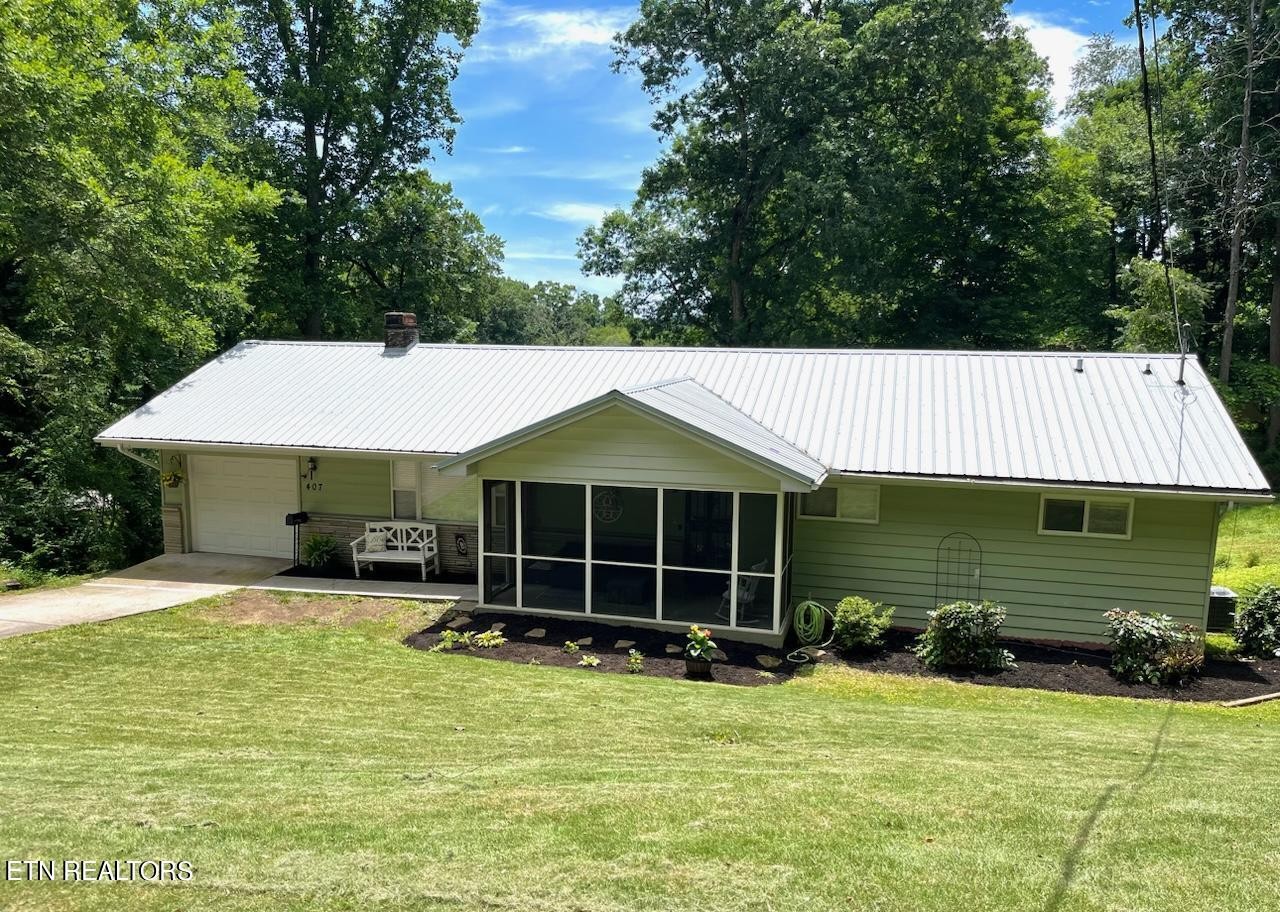 407 Delaware Avenue Oak Ridge, TN 37830 - Photo 39 of 40 a front view of a house with a yard and garage
