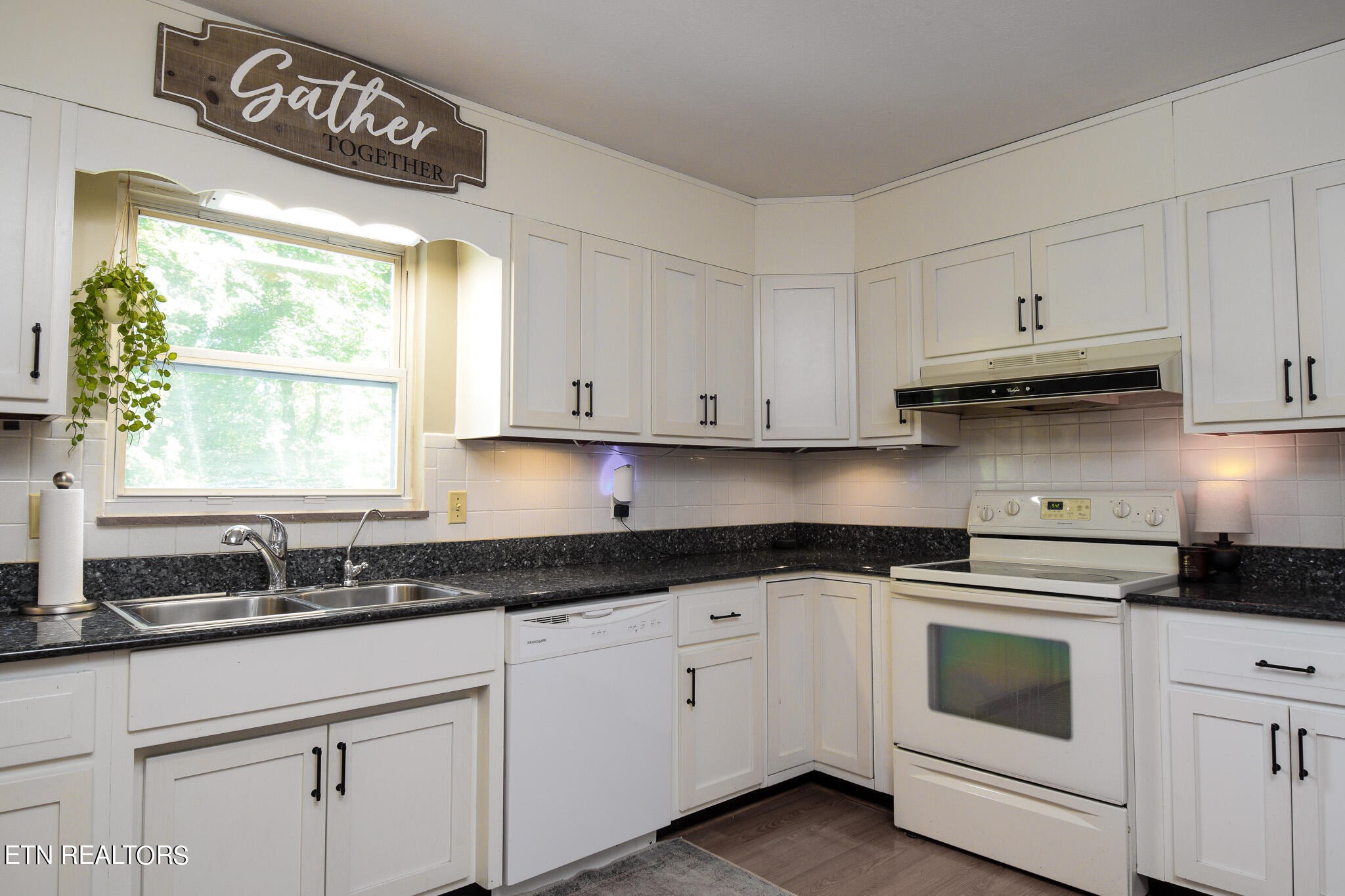 407 Delaware Avenue Oak Ridge, TN 37830 - Photo 4 of 40 a kitchen with granite countertop white cabinets and a window