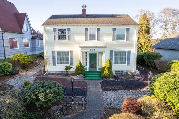 a front view of a house with garden