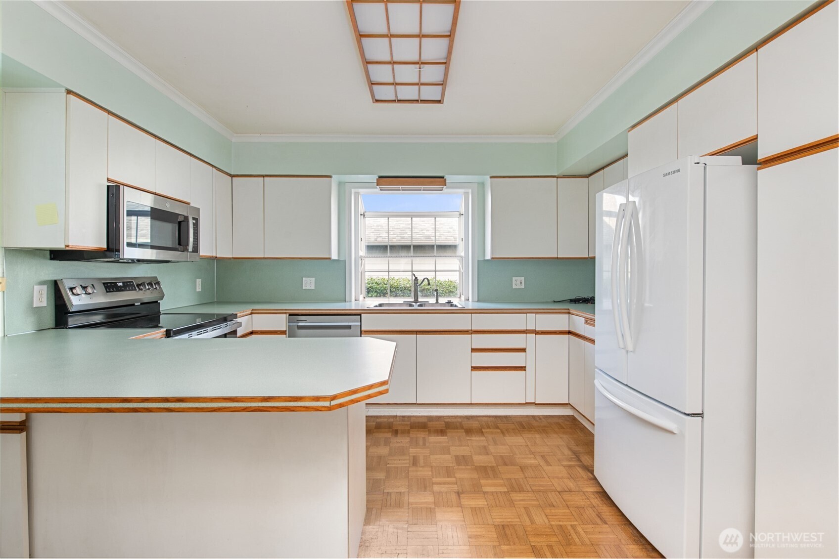 614 1st Avenue Aberdeen, WA 98520 - Photo 12 of 38 a kitchen with stainless steel appliances granite countertop a refrigerator sink stove and microwave
